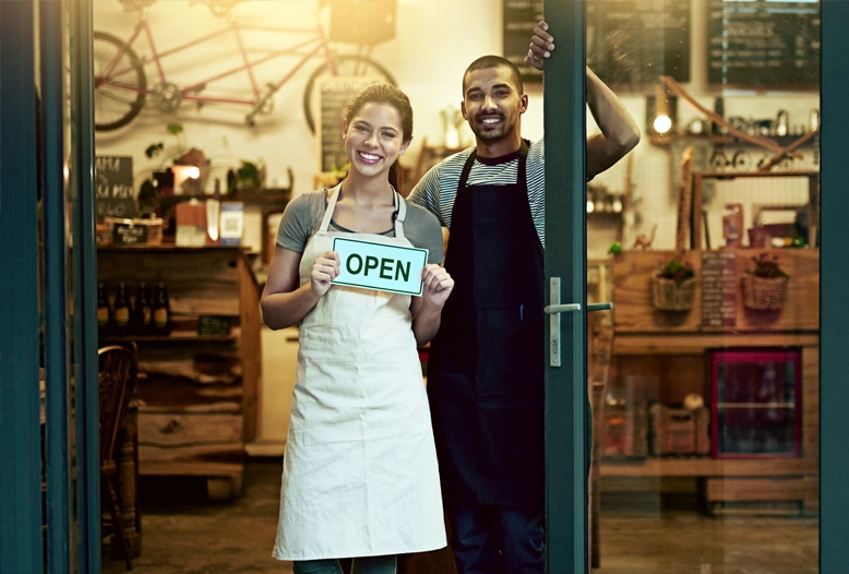 two shop workers opening up shop