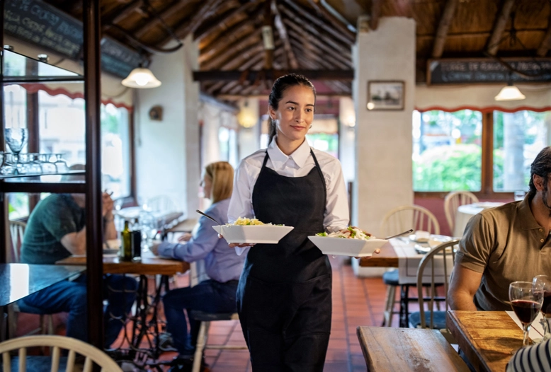 female restaurant server holding two dishes